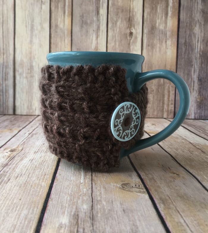 brown knit mug cozy on wooden background