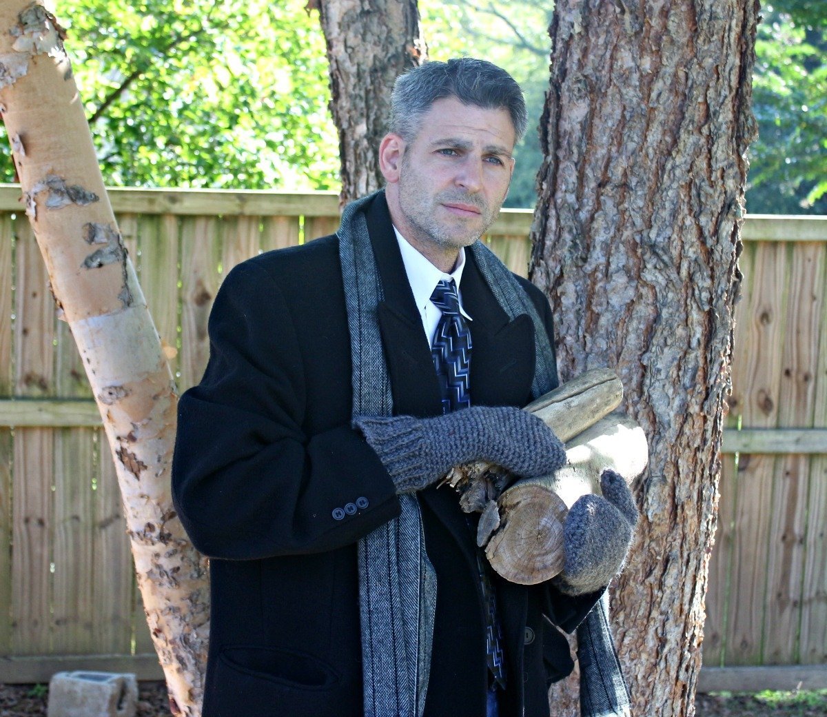 author's husband modeling his pair of men's crochet mittens