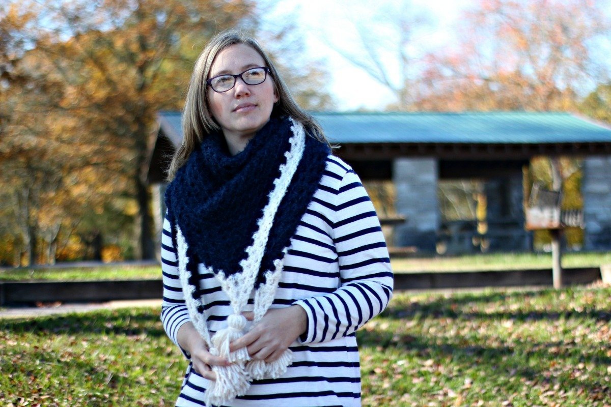 the author wearing the hygge shawl, a free crochet shawl pattern