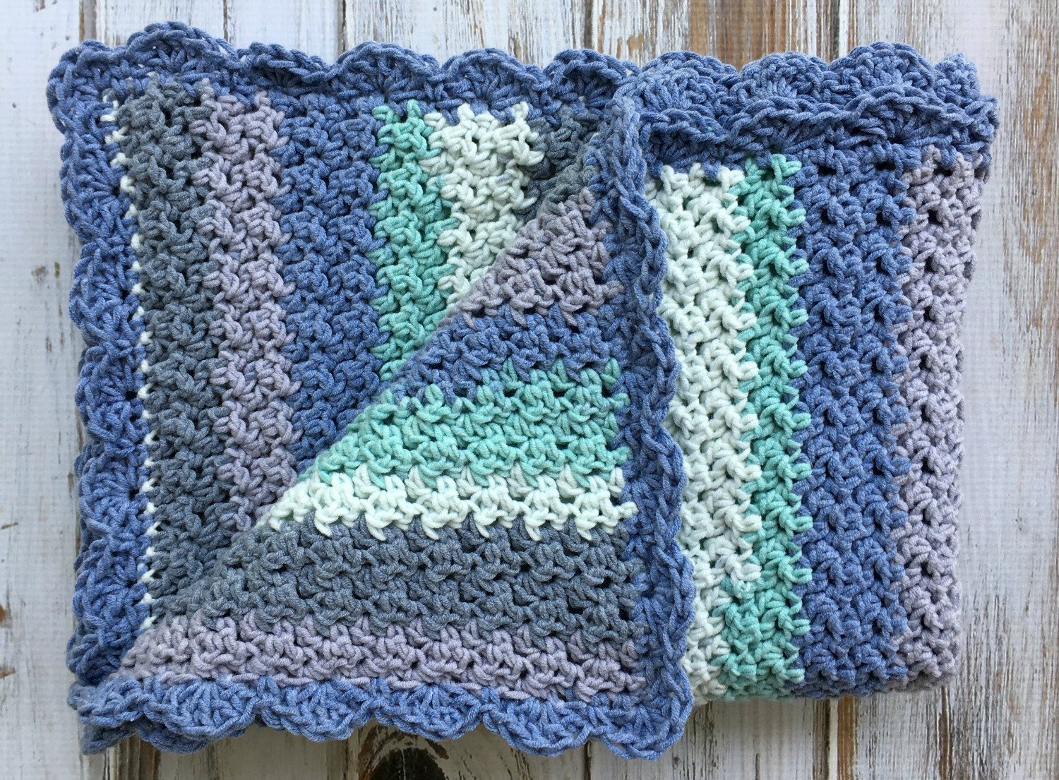 caron cotton cakes baby blanket with corner folded back showing texture