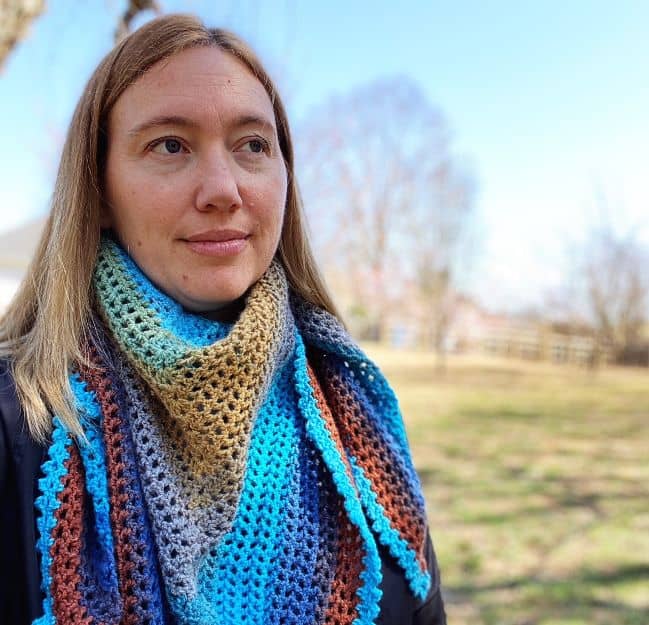 close up of author wearing the beginner crochet triangle shawl as a scarf