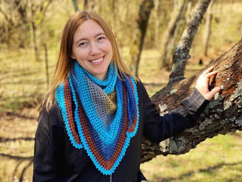 author wearing the beginner crochet triangle shawl as scarf