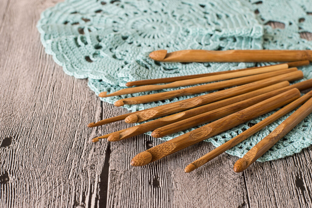 set of wooden crochet hooks on doily