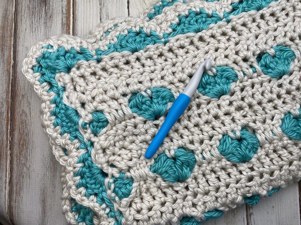Be Still My Heart!  This blanket uses a simple heart stitch to create this simple heart pattern.  Free crochet pattern!
