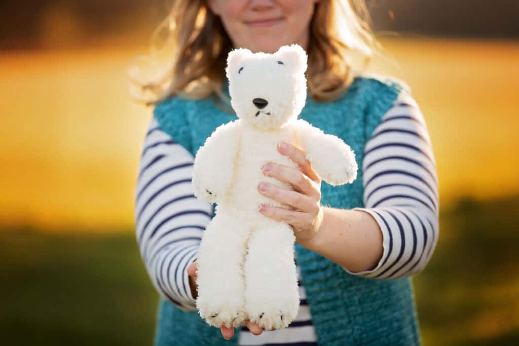 designer holding knit polar bear
