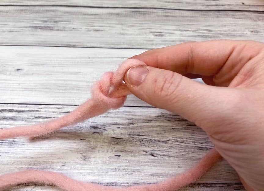 hand pulling loop through to form slip knot