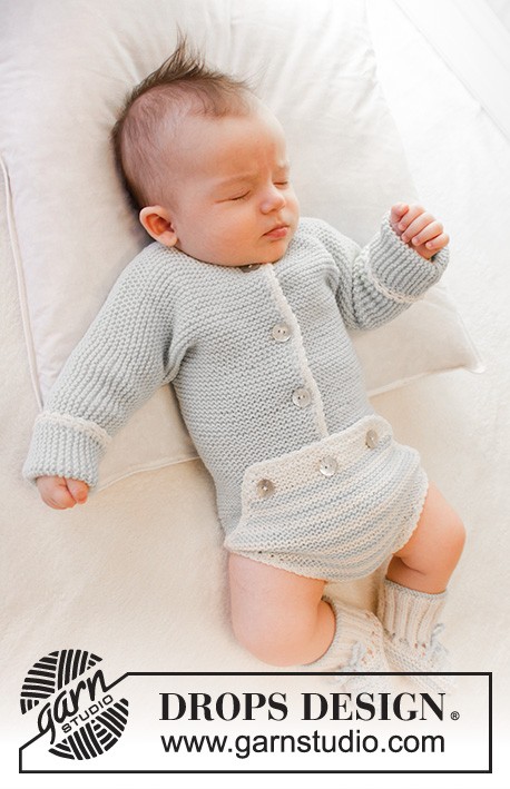 sleeping baby wearing a knitted onesie and socks