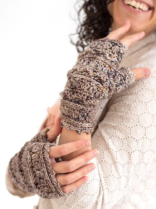 woman modeling pair of crochet fingerless gloves