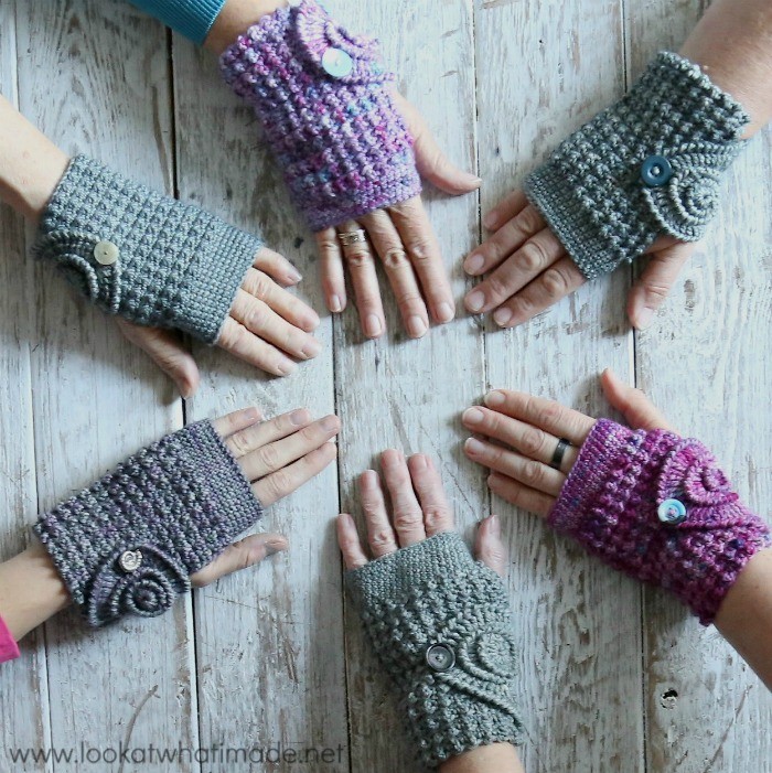 hands modeling diffeent colors of crochet fingerless mitts