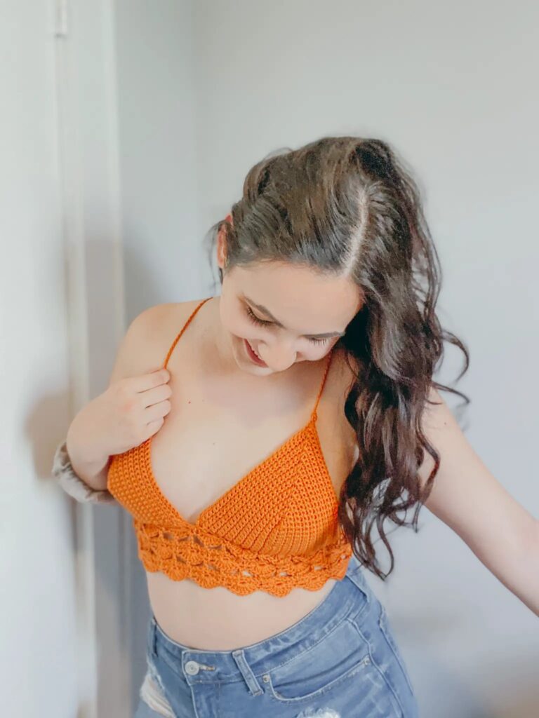 woman wearing an orange crochet bralette
